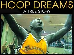 The DVD cover of 'Hoop Dreams' is shown with a basketball player in a yellow top raises his arms aloft in celebration and ecstasy. 
