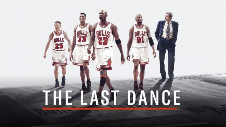 In this promotional poster for the 'The Last Dance', Jordan (centre), Pippen (left) and Rodman are seen walking  in their kits with Steve Kerr (far left) and a suited Phil Jackson (far right)