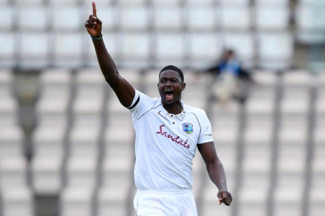 West Indies captain Jason Holder holds his arms aloft during the first test match against England